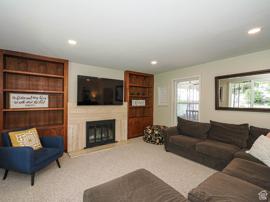 Living room featuring recessed lighting, carpet flooring, and a high end fireplace
