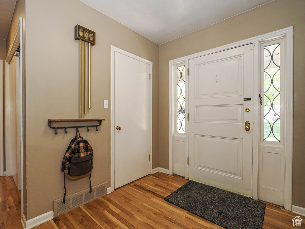 Entrance foyer featuring baseboards, visible vents, and light wood-type flooring