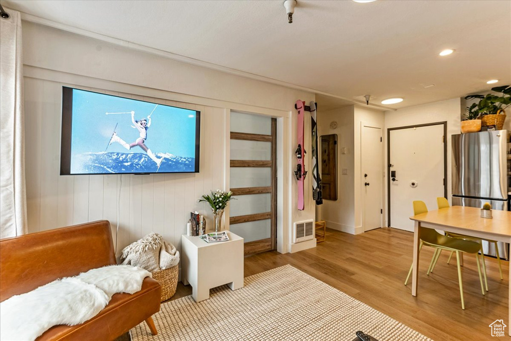 Living room with recessed lighting, visible vents, and light wood-style flooring