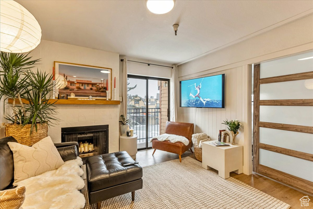 Sitting room featuring a fireplace and wood finished floors