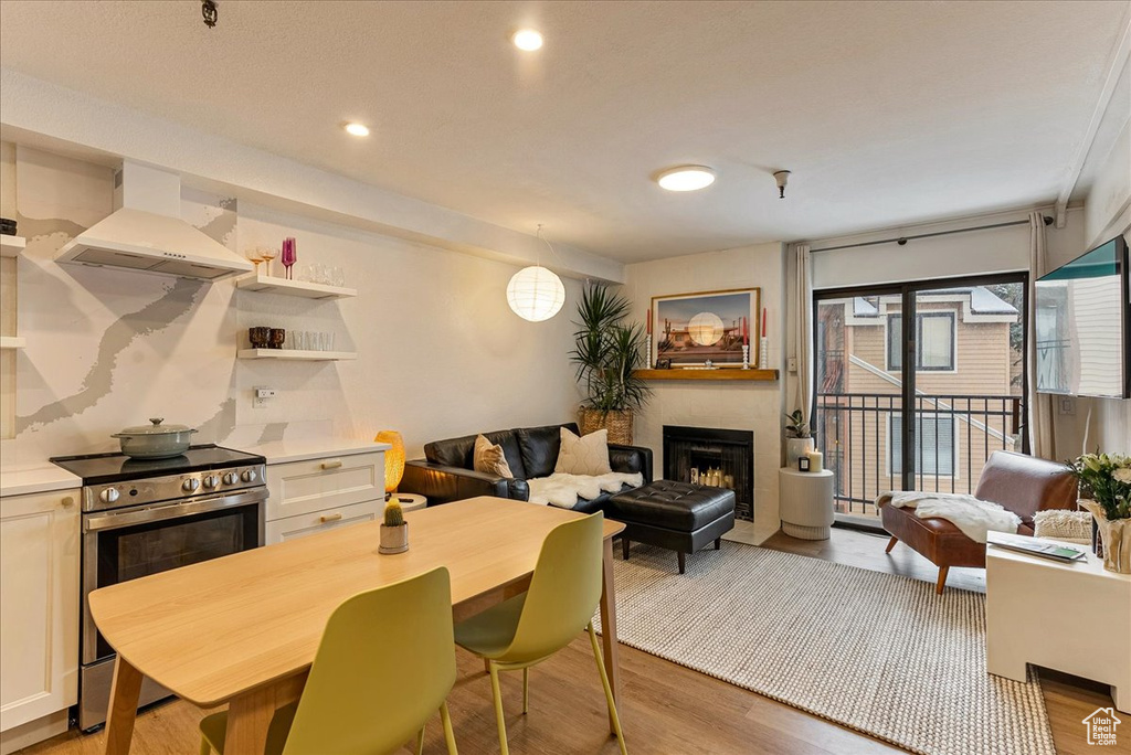 Dining space featuring a fireplace and light wood-type flooring