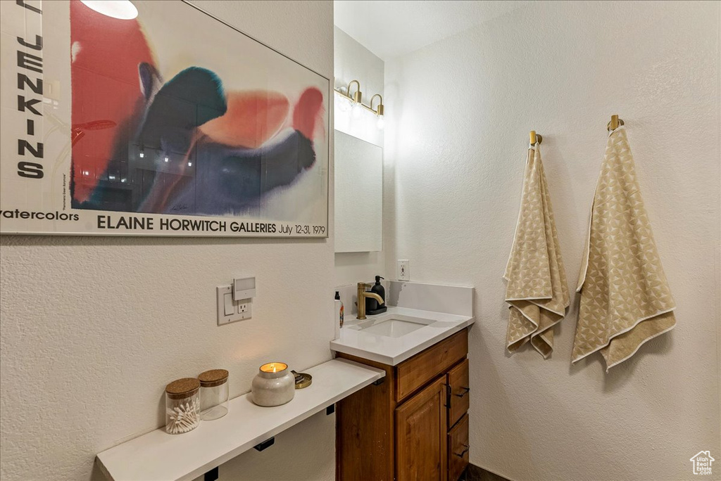 Bathroom featuring vanity and a textured wall