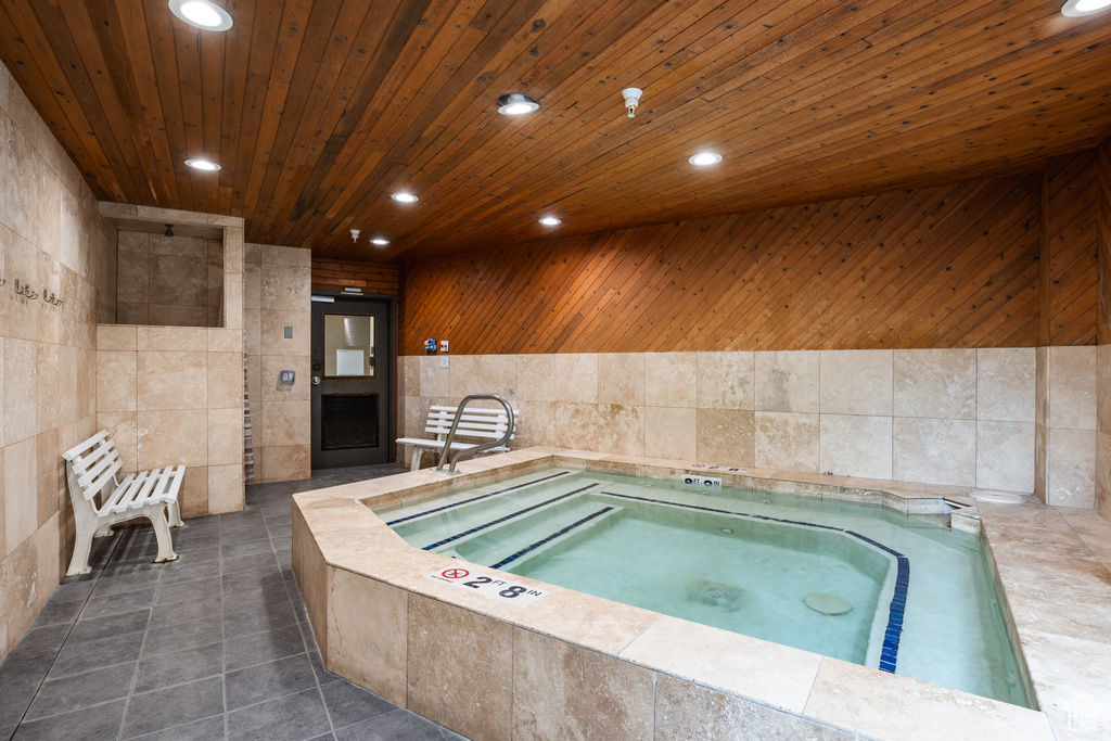 View of pool with an indoor hot tub and a pool