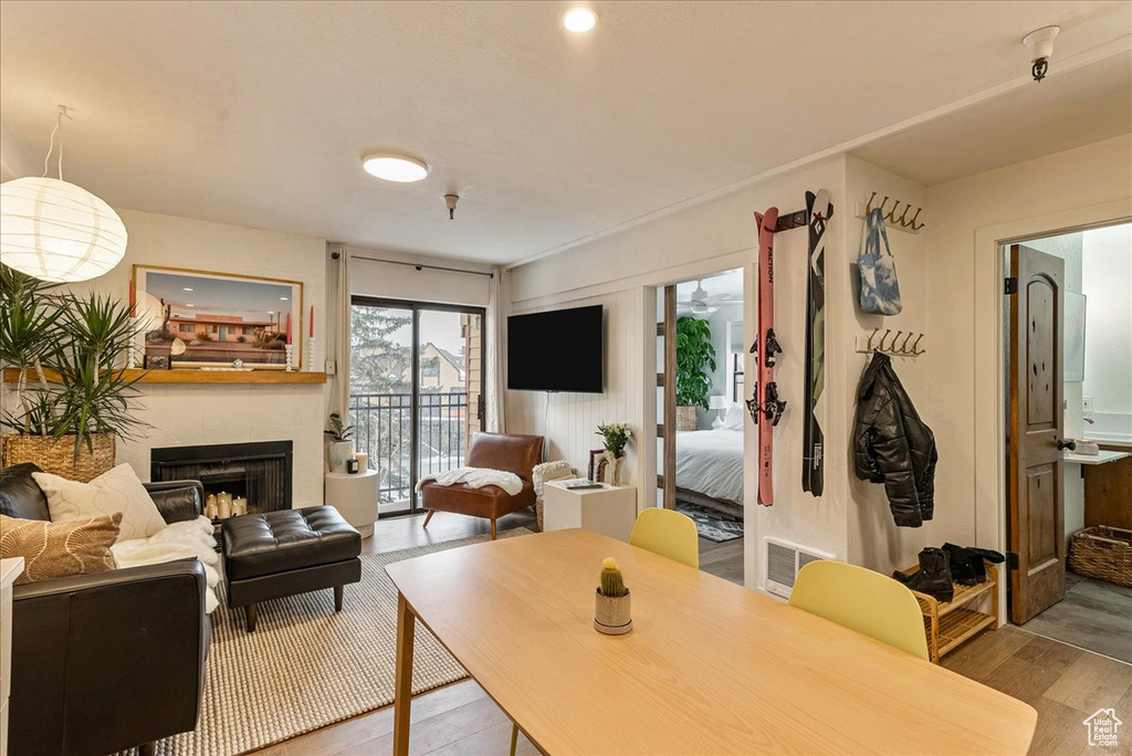 Living area with visible vents, wood finished floors, and a fireplace