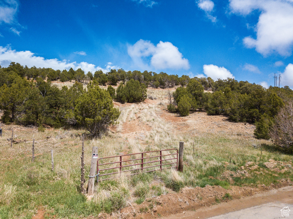 View of yard featuring a rural view and fence