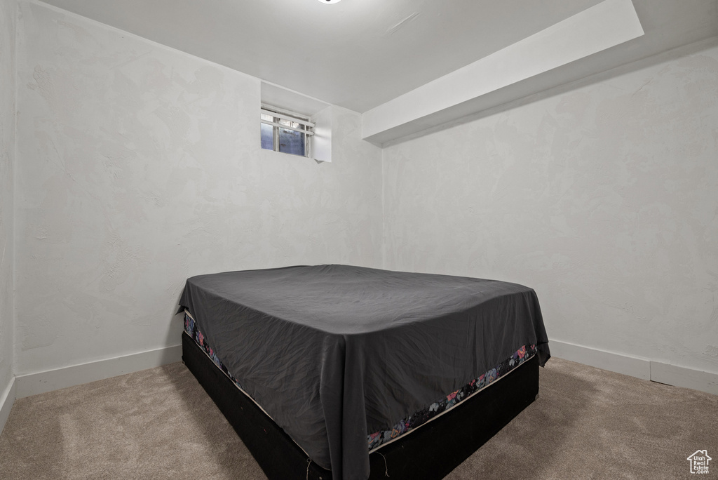 Carpeted bedroom featuring baseboards
