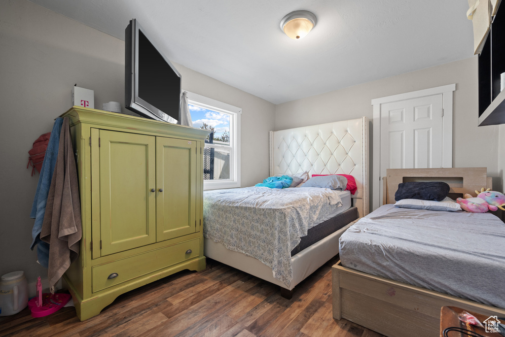 Bedroom with dark wood-style floors