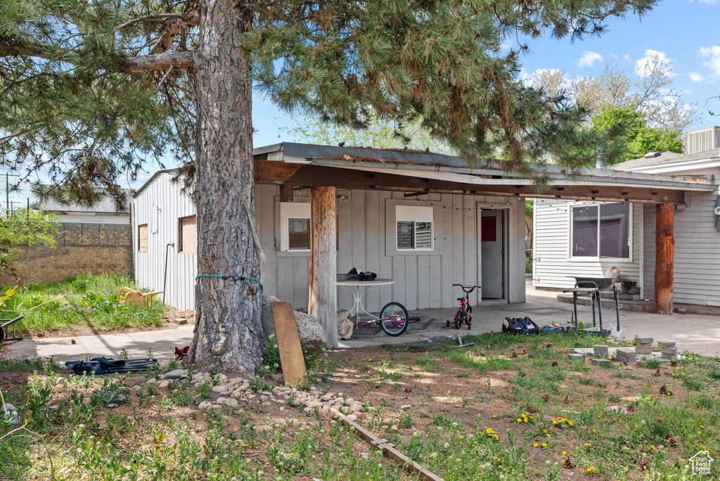 Rear view of property featuring a patio and board and batten siding