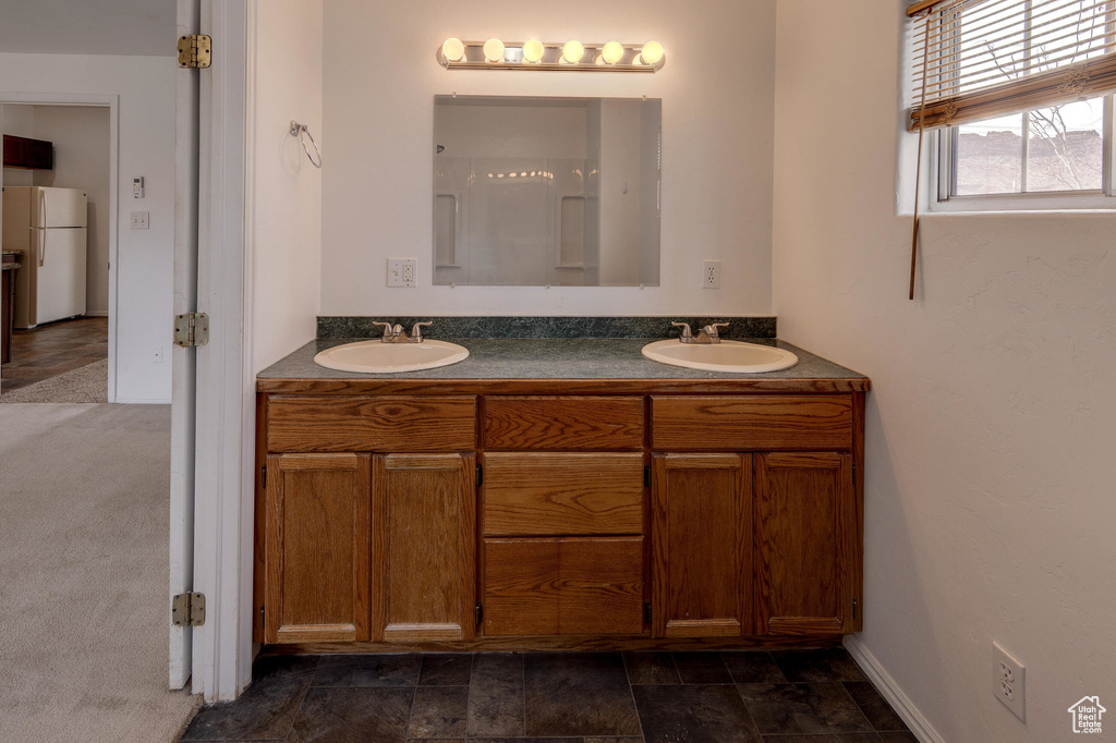 Full bath featuring double vanity and a sink