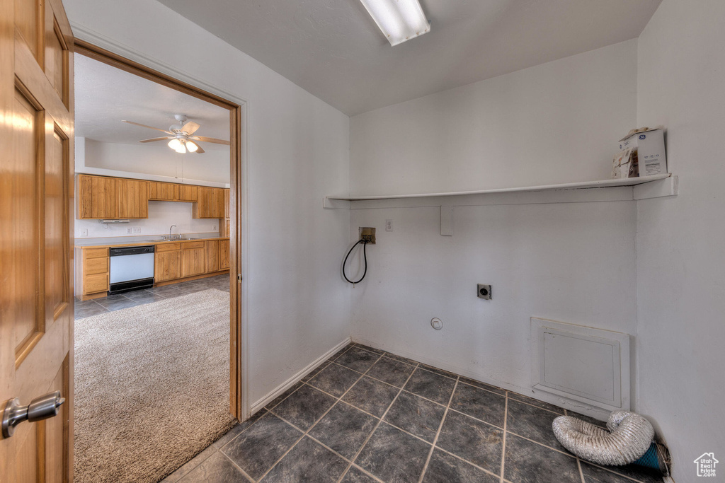 Clothes washing area with hookup for an electric dryer, a sink, ceiling fan, washer hookup, and laundry area