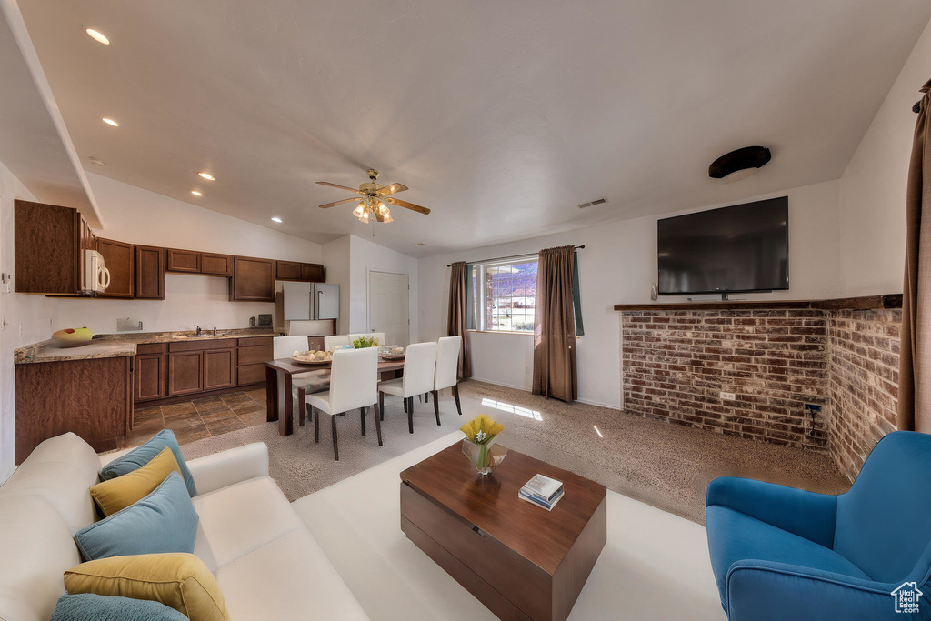 Living room featuring recessed lighting, ceiling fan, lofted ceiling, and visible vents