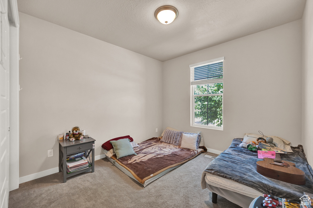 Carpeted bedroom featuring baseboards