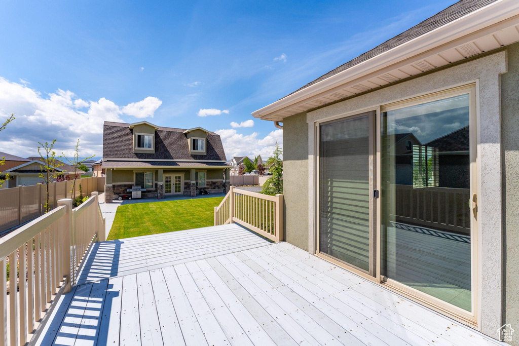 Deck with a yard, french doors, and a fenced backyard