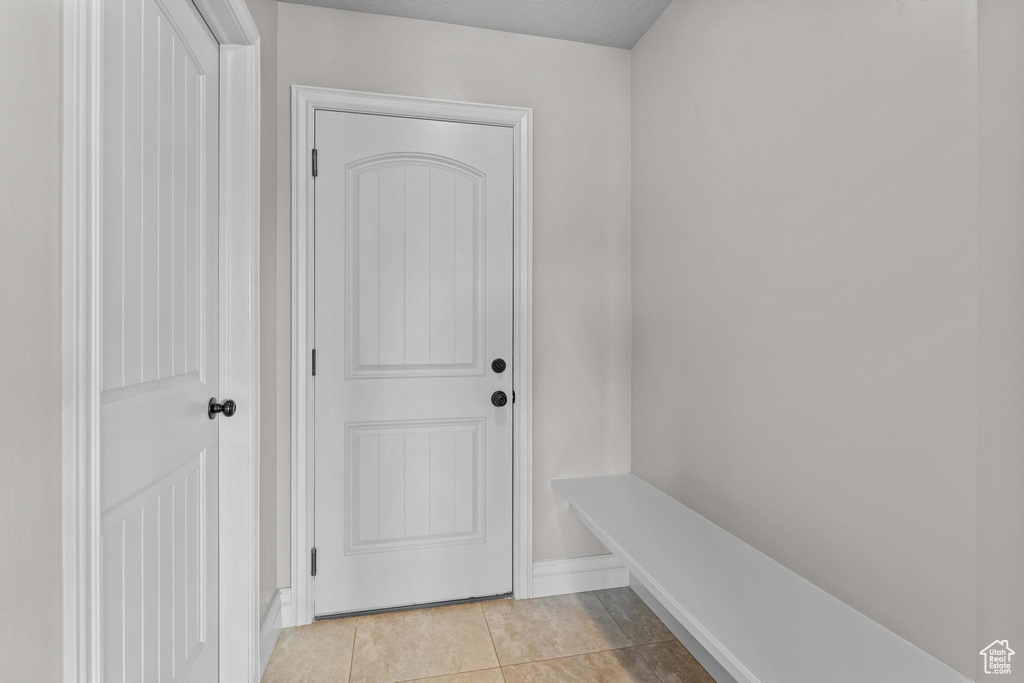 Interior space featuring light tile patterned floors and baseboards