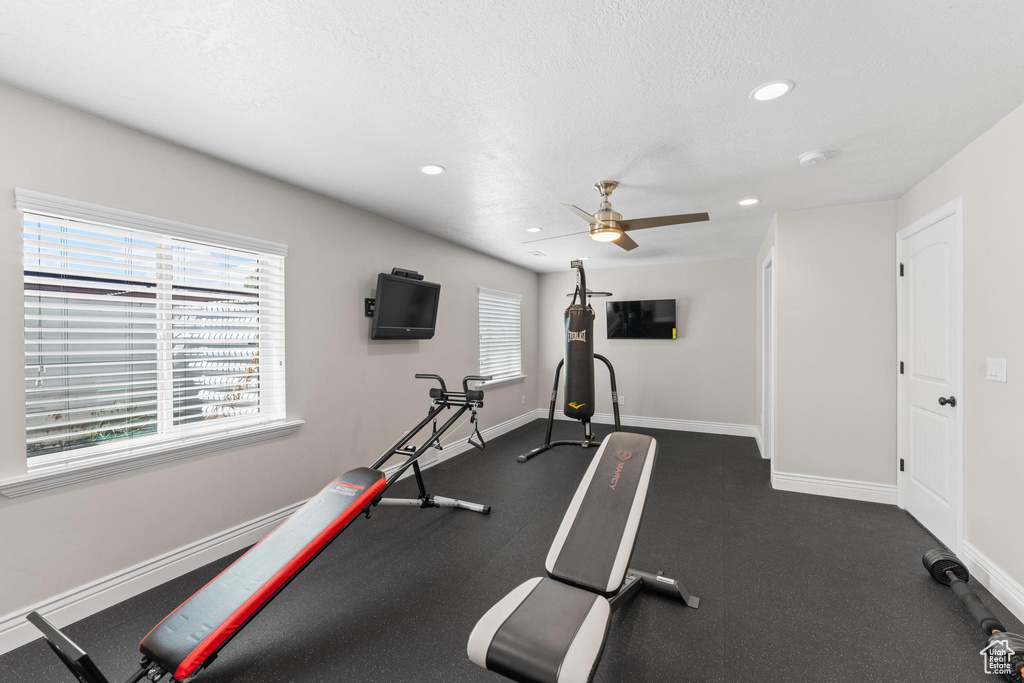 Workout area featuring recessed lighting, a ceiling fan, baseboards, and a textured ceiling