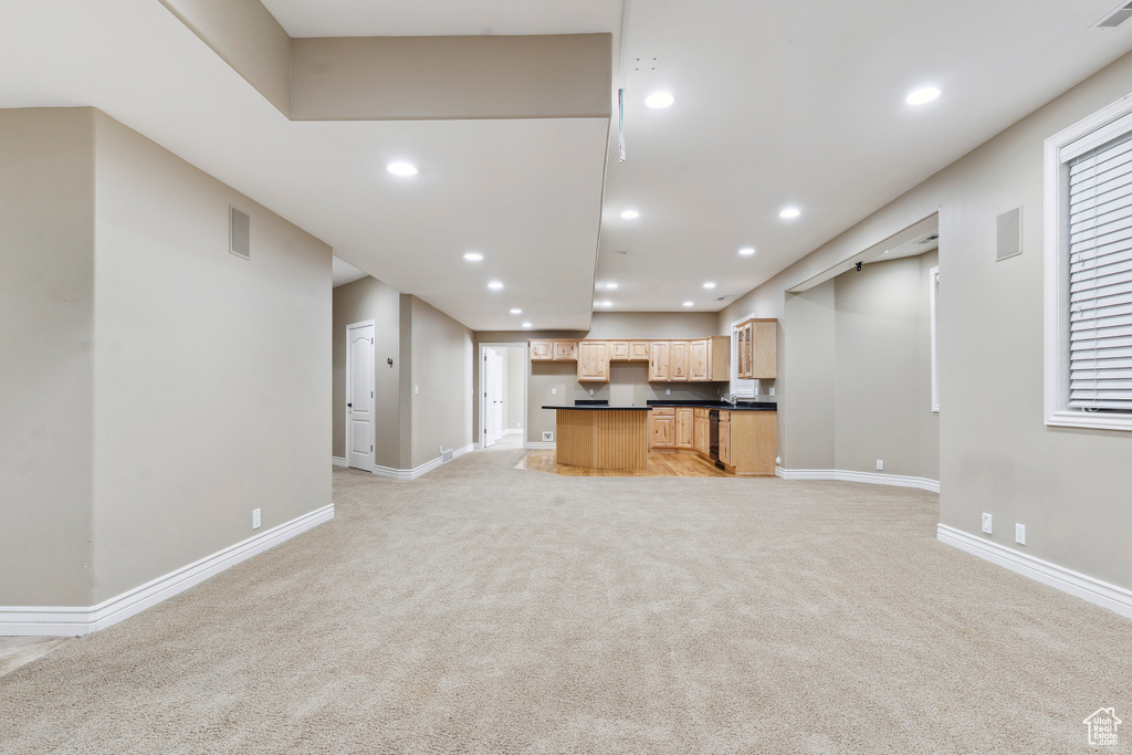 Unfurnished living room with light colored carpet, recessed lighting, and baseboards