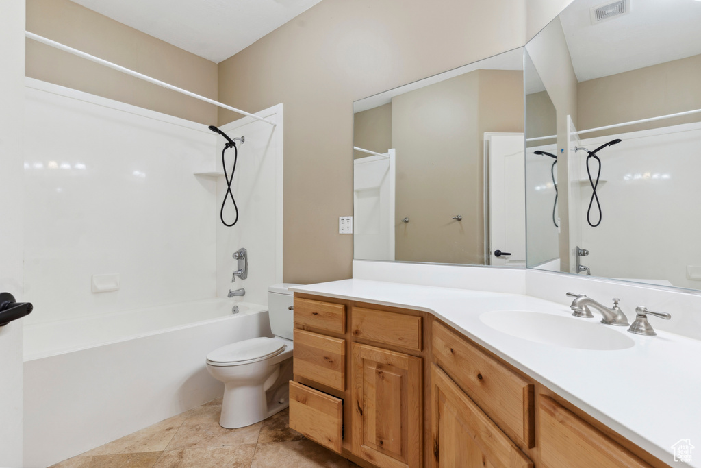 Bathroom with toilet, visible vents, shower / tub combination, and vanity