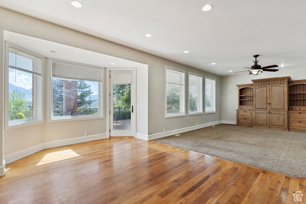 Unfurnished living room featuring recessed lighting and a healthy amount of sunlight