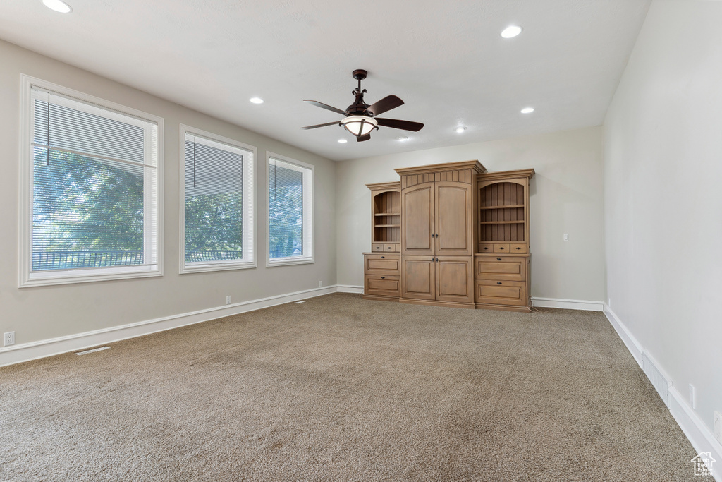 Carpeted spare room featuring recessed lighting, a ceiling fan, and baseboards