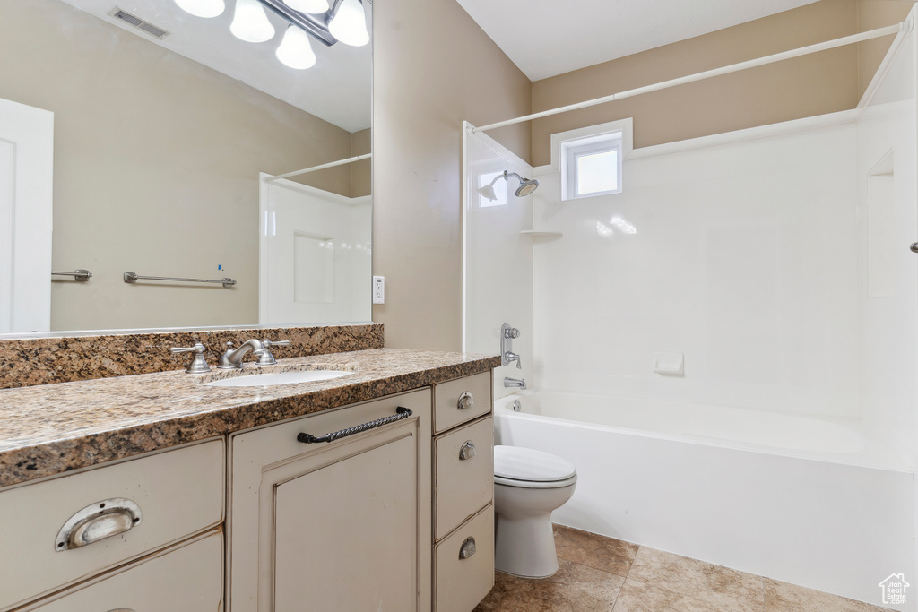 Bathroom with toilet, visible vents, bathing tub / shower combination, and vanity