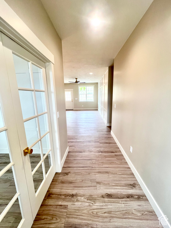 Hallway featuring baseboards and wood finished floors