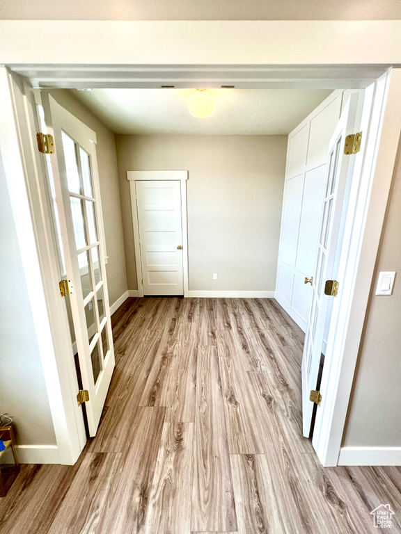 Interior space featuring baseboards and light wood-style flooring