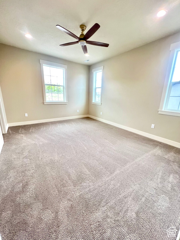 Carpeted spare room with recessed lighting, ceiling fan, and baseboards