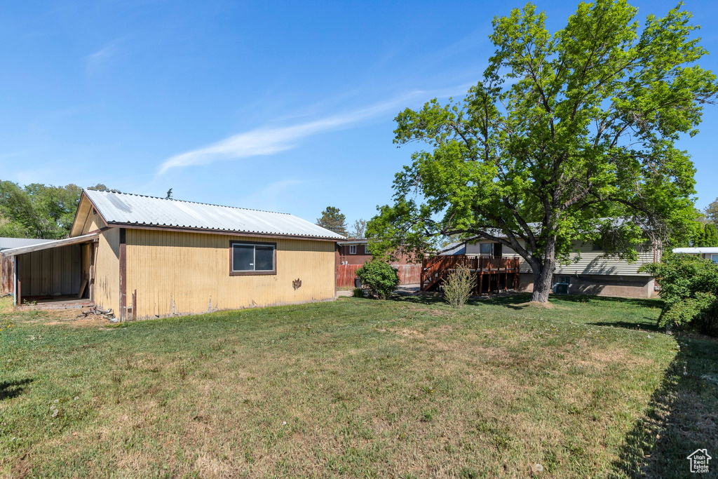 View of yard featuring an outbuilding and a carport