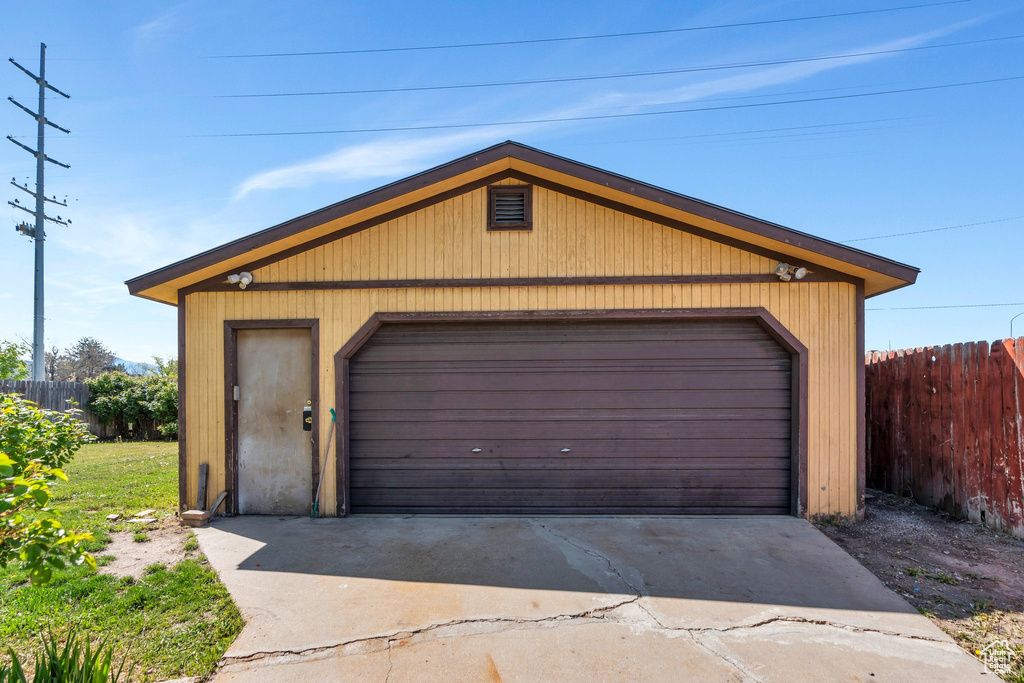 Detached garage featuring fence