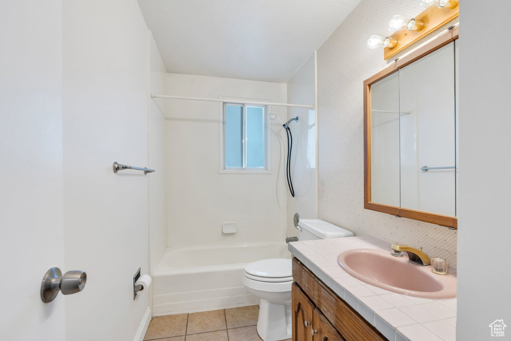 Full bath featuring vanity, tile patterned flooring, toilet, and bathing tub / shower combination
