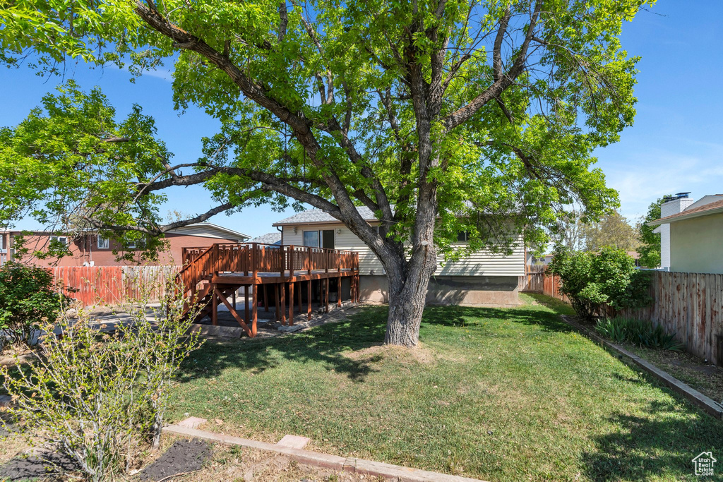 View of yard featuring stairway, a wooden deck, and a fenced backyard