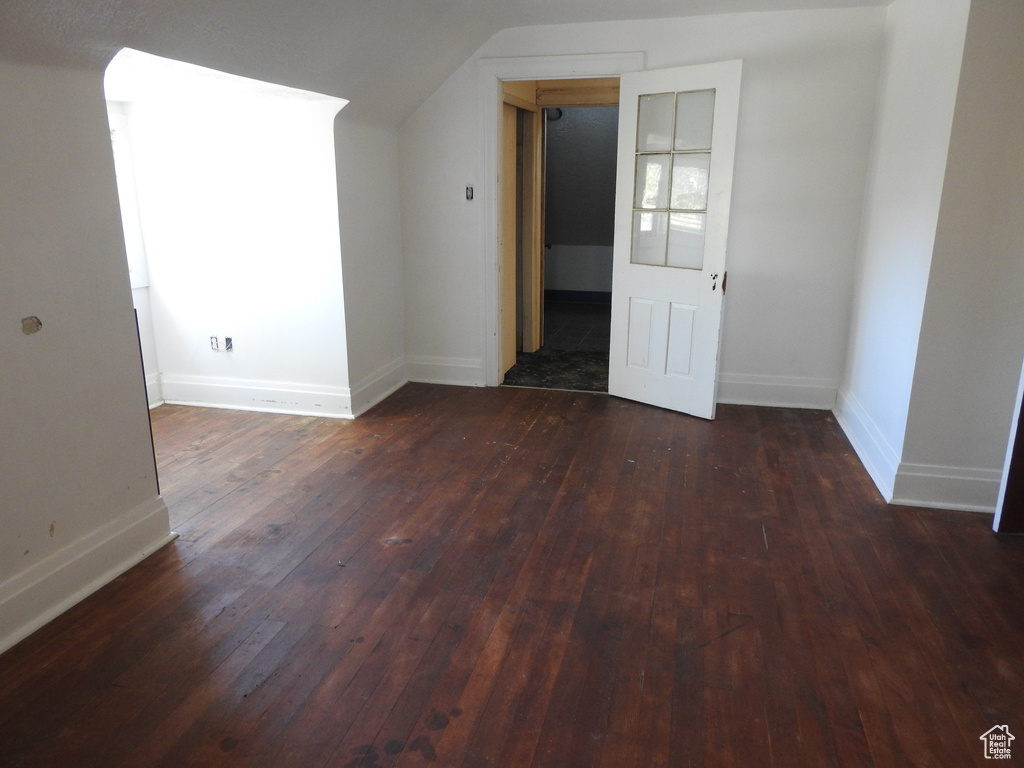 Bonus room with baseboards, wood-type flooring, and vaulted ceiling