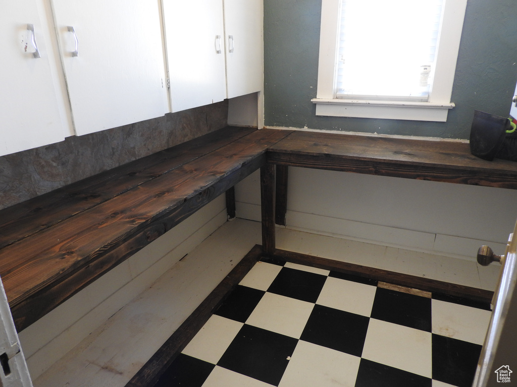 Interior space featuring tile patterned floors and white cabinets