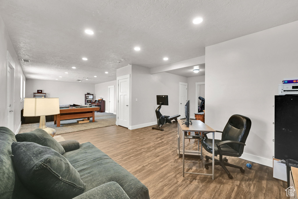 Living room with recessed lighting, baseboards, and wood finished floors