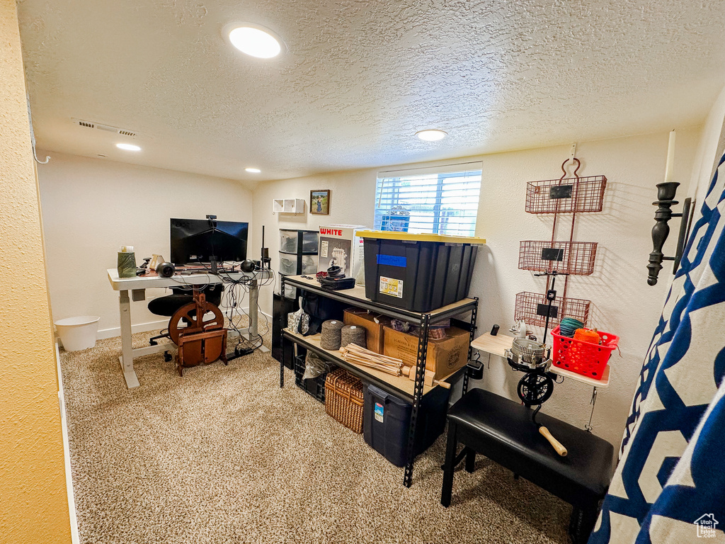 Carpeted office with visible vents, recessed lighting, and a textured ceiling