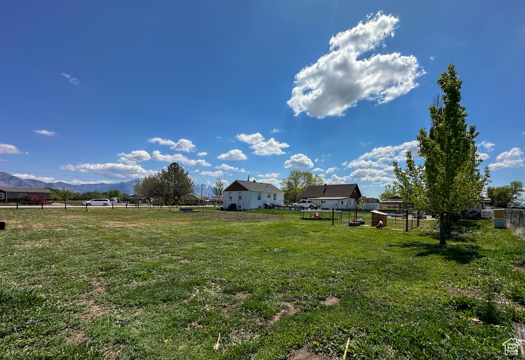 View of yard featuring a mountain view and fence