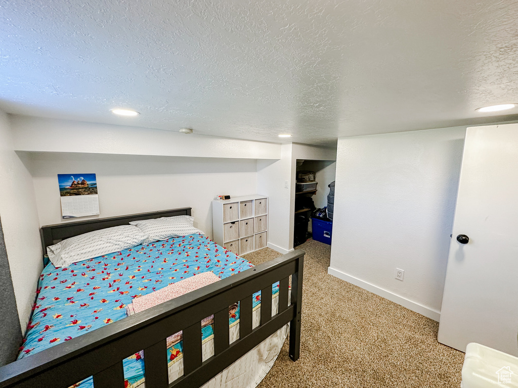 Bedroom with baseboards, carpet, a textured ceiling, and recessed lighting
