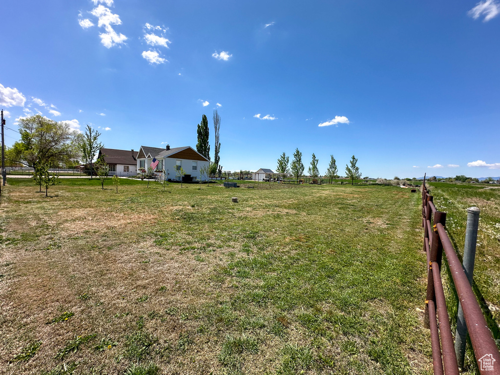 View of yard featuring a rural view and fence