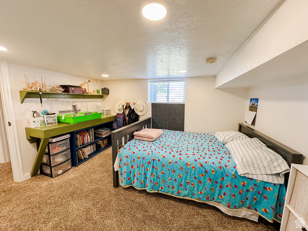 Carpeted bedroom featuring a textured ceiling