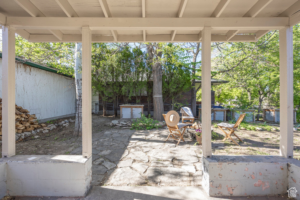 View of patio featuring fence