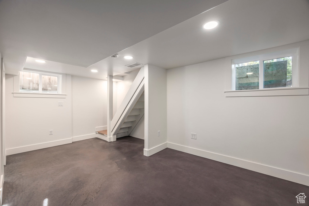 Below grade area with baseboards, recessed lighting, visible vents, and stairway