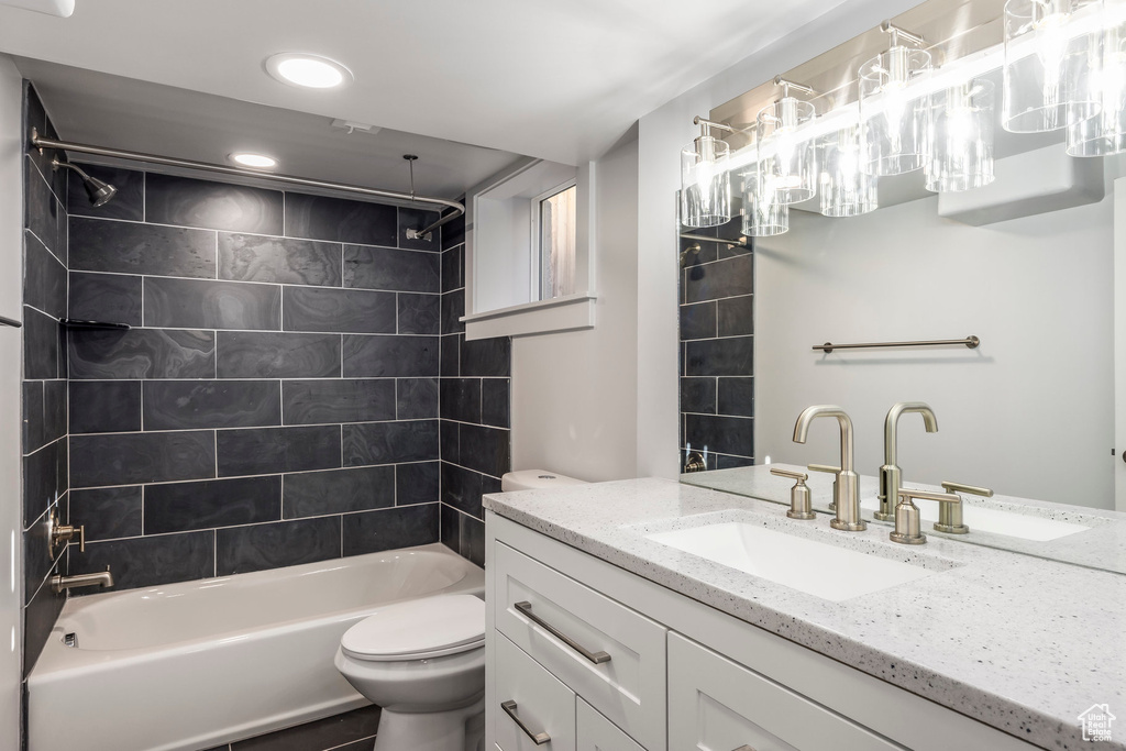 Bathroom featuring recessed lighting, bathtub / shower combination, toilet, and vanity