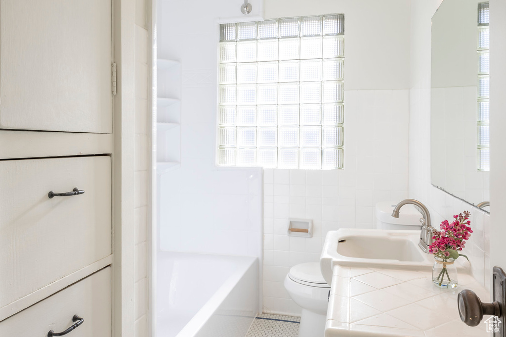 Full bathroom featuring vanity, tile patterned floors, toilet, and tile walls