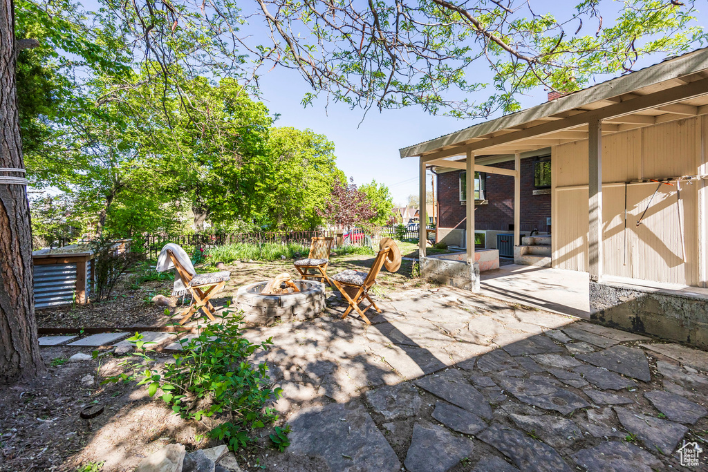 View of patio / terrace featuring fence and a fire pit