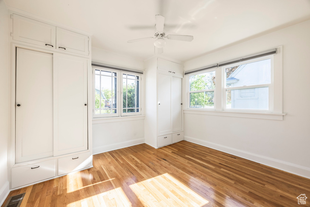 Unfurnished bedroom with baseboards, visible vents, and light wood-style flooring
