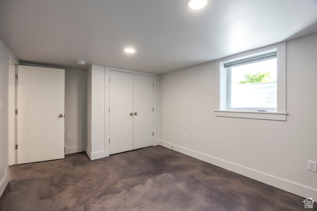 Unfurnished bedroom featuring baseboards, a closet, and recessed lighting