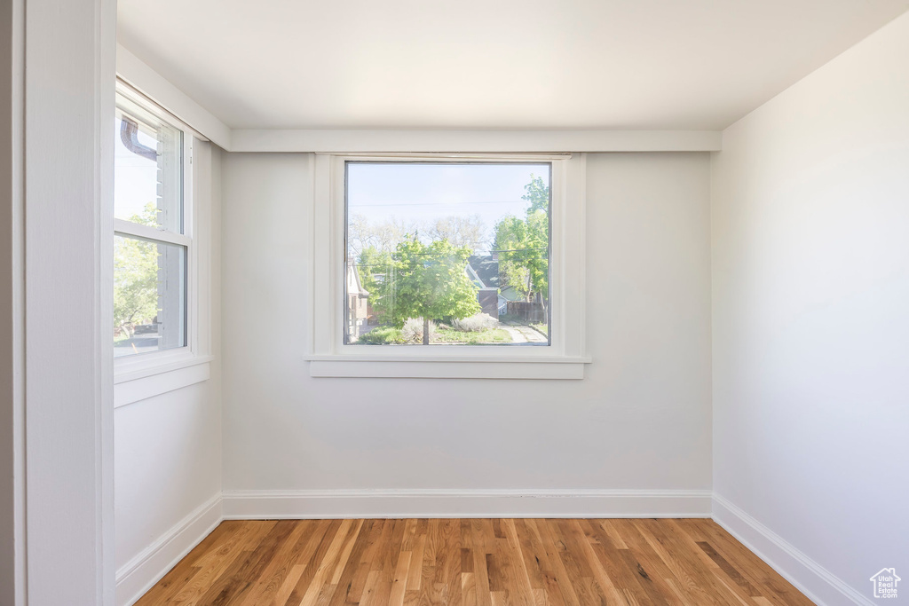 Spare room with baseboards and light wood finished floors