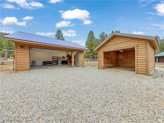 Detached garage featuring fence