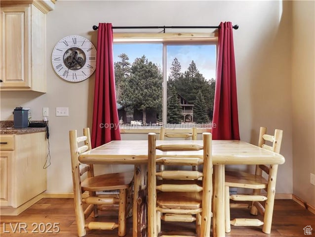 Dining area with baseboards and light wood-style flooring