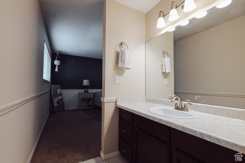 Bathroom with vanity and baseboards